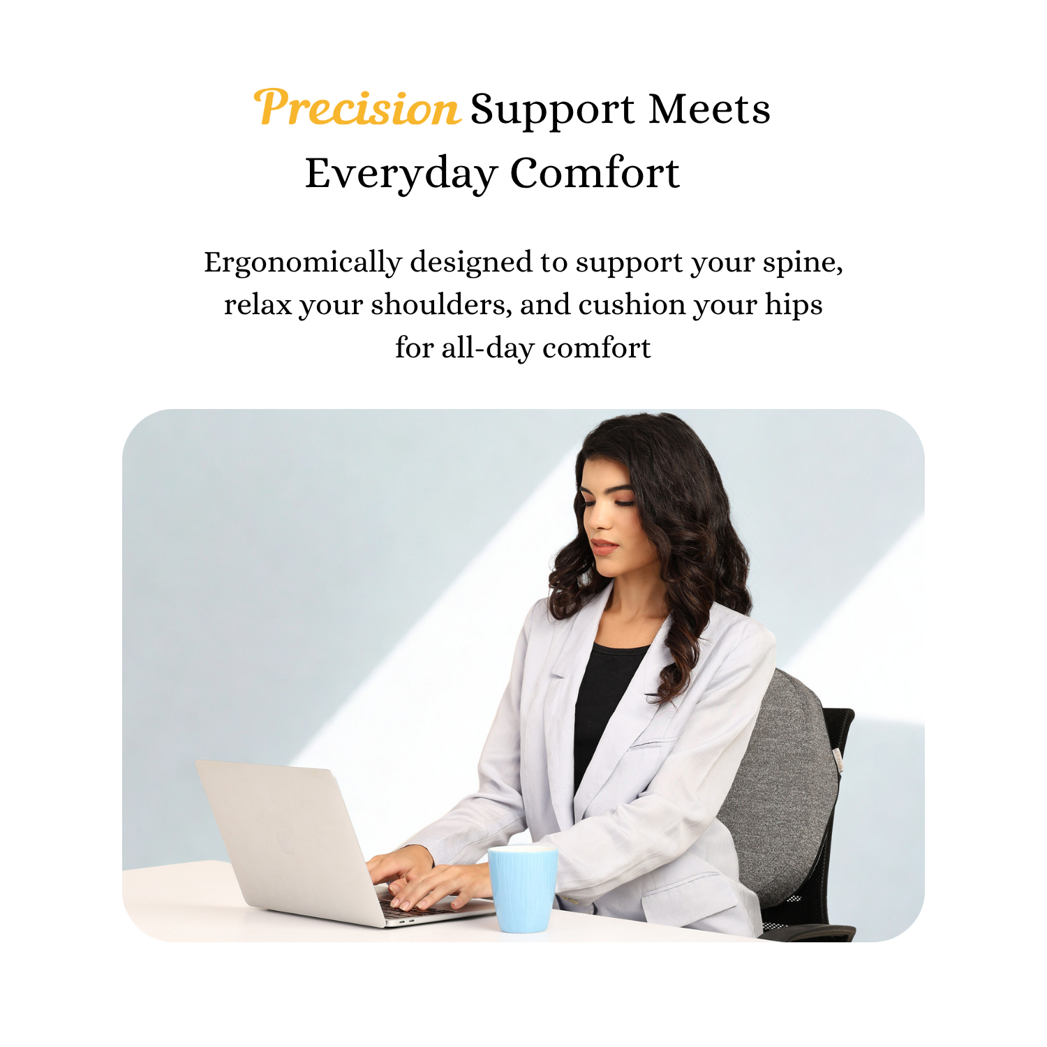 Woman sitting at desk using laptop with memory foam back support for prolonged sitting in office chair
